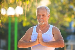 Older man in yoga pose shutterstock 737381545 web