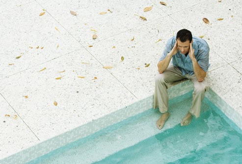 getty rf photo of man with feet in pool